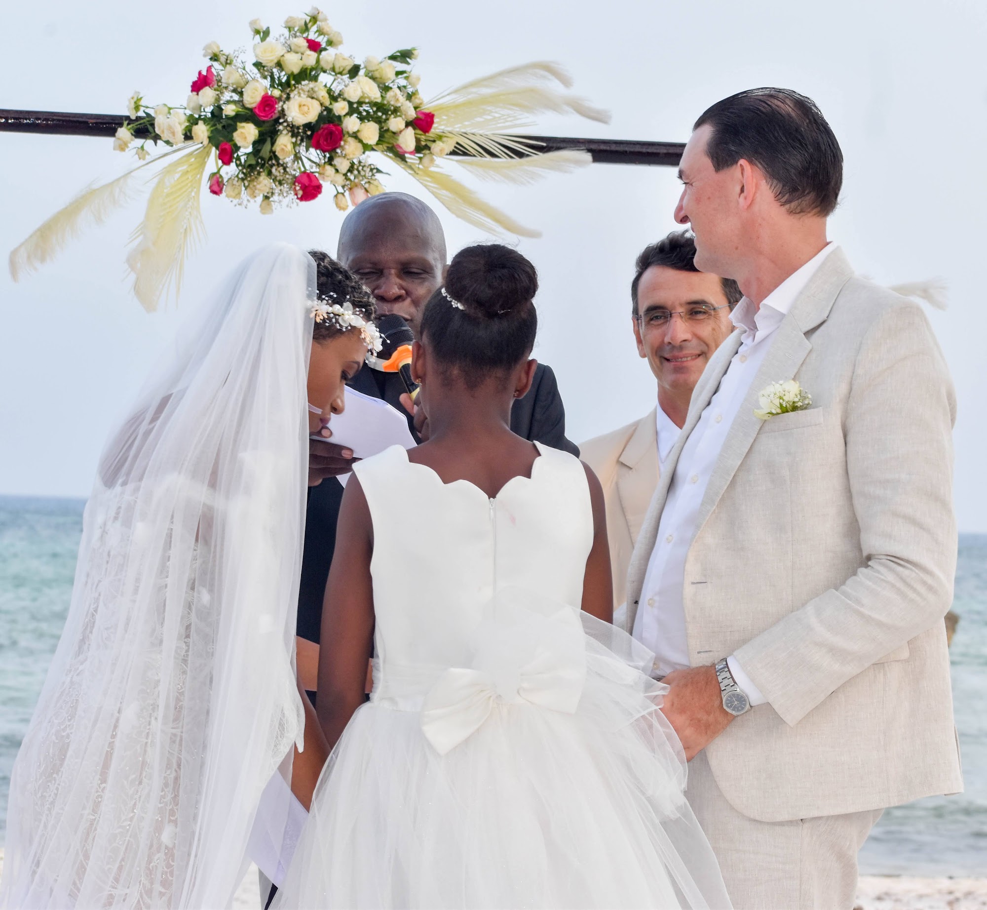 Bride and groom at a beach wedding arch in Kenya