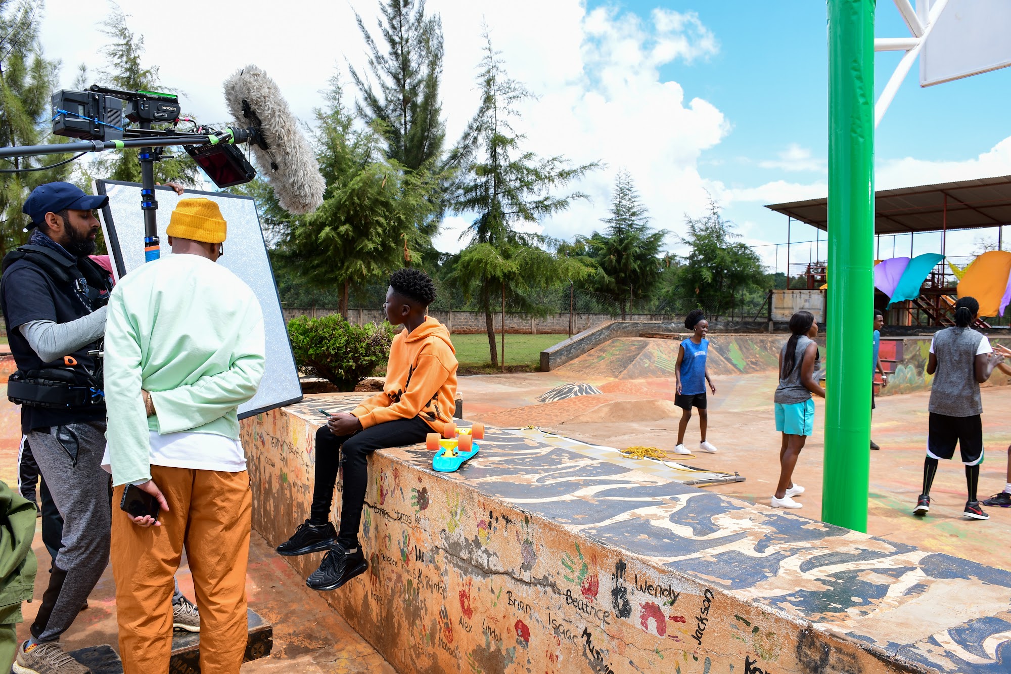 Videographer filming outdoors on a gimbal in Kenya